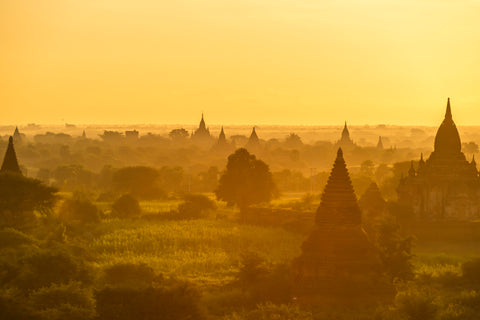 A yellow, orange sunrise over the temples in Bagan, Myanmar 