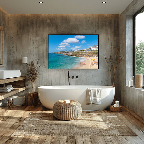 Bronte Beach in Sydney, Australia, with massive white clouds over the turquoise ocean and a rocky coastline.