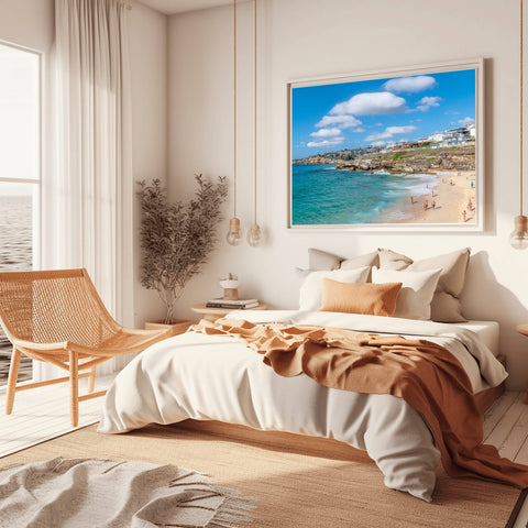 Bronte Beach in Sydney, Australia, with massive white clouds over the turquoise ocean and a rocky coastline.