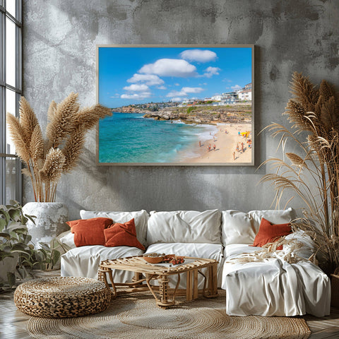 Bronte Beach in Sydney, Australia, with massive white clouds over the turquoise ocean and a rocky coastline.