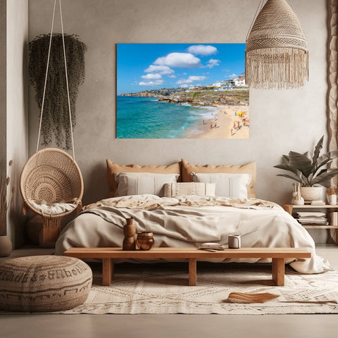 Bronte Beach in Sydney, Australia, with massive white clouds over the turquoise ocean and a rocky coastline.