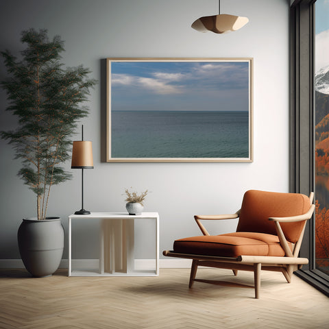 A minimalist horizontal view of the Mediterranean Sea horizon in Cannes, France, with pale blue water and a clear sky.
