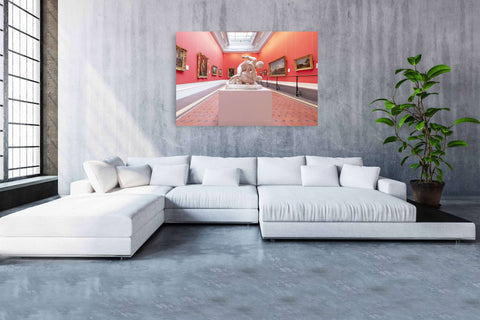 Interior photography of a gallery room in the National Gallery of Ireland, featuring red walls, a white marble statue, and framed paintings.