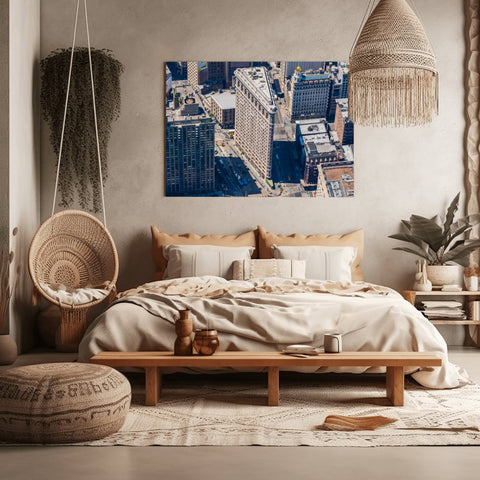 An aerial helicopter photograph looking down at the triangular roof of the Flatiron Building at the intersection of 5th Ave and Broadway.