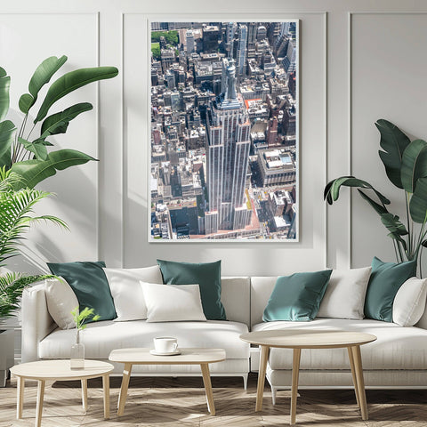 A high-altitude helicopter photograph looking directly down at the spire and setbacks of the Empire State Building.