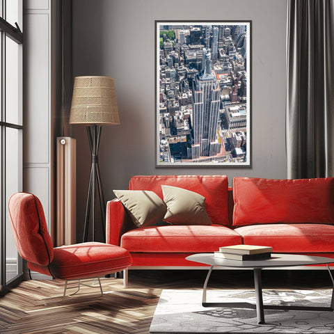 A high-altitude helicopter photograph looking directly down at the spire and setbacks of the Empire State Building.