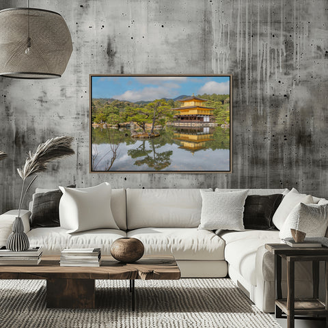 The top two floors of the Kinkaku-ji temple covered in gold leaf, reflecting perfectly in the Mirror Pond (Kyoko-chi) surrounded by traditional Japanese pines.