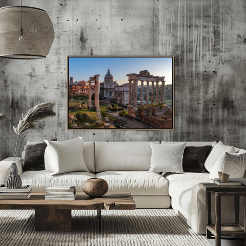 The sun rising over the ancient pillars and weathered ruins of the Imperial Fora in Rome, casting long shadows and a golden glow over the historical site.