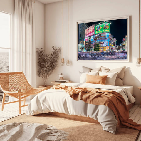 A long-exposure night shot of Shibuya Crossing in Tokyo, showing the blur of thousands of pedestrians crossing under massive neon billboards.