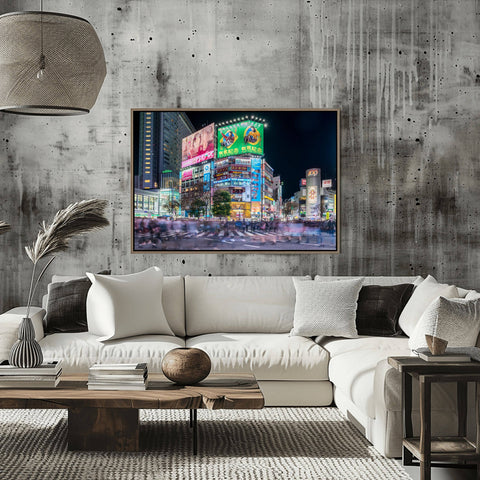 A long-exposure night shot of Shibuya Crossing in Tokyo, showing the blur of thousands of pedestrians crossing under massive neon billboards.