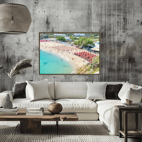 High-angle tilt shift view of Super Paradise Beach in Mykonos, featuring turquoise water and tiny-looking blue umbrellas.