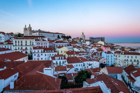A pink sunset over the city of Lisbon in Portugal