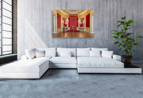 A luxurious interior photograph of a red-walled royal room in the Royal Castle of Warsaw, featuring gold molding and regal furnishings.