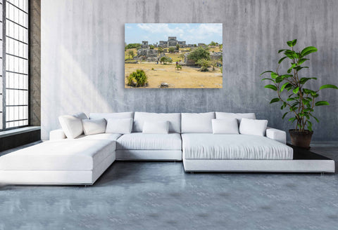 Tilt shift photography of the Tulum Mayan ruins on the coast of Mexico, making the ancient stone structures and turquoise sea look like a miniature model.